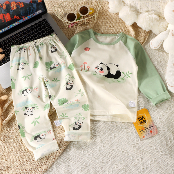 Children's pajama set with panda design on a textured surface