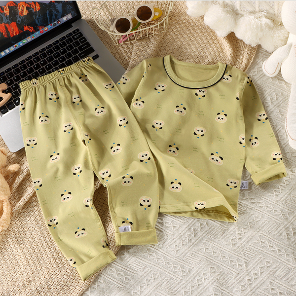 Children's pajama set with panda pattern on a textured surface